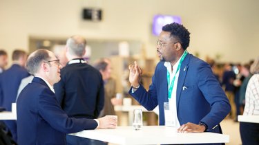 men networking at table